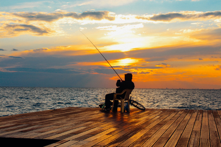 a person fishing on a deck